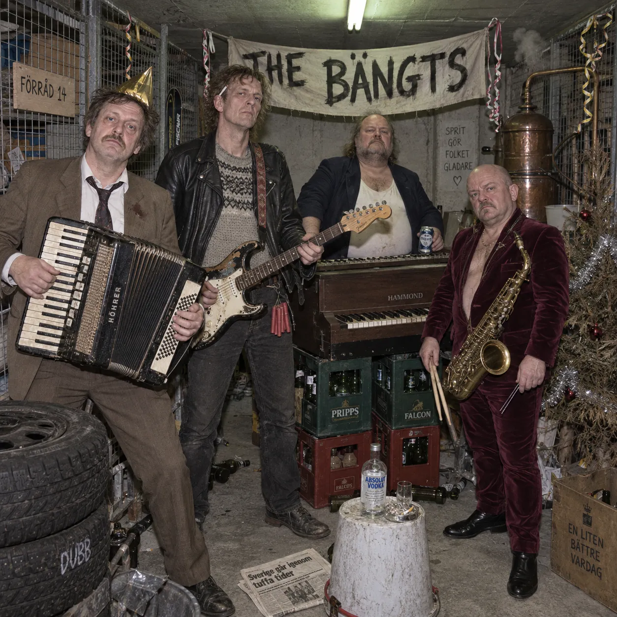 The Bängts posing in basement storage unit 14 with accordion, guitar, Hammond organ and saxophone, surrounded by beer crates, winter tyres and a copper still